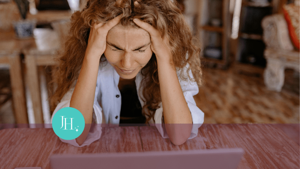 woman with head in hands, looking distressed. Struggling to manage uncertainty or keep sane during stress or chaos.