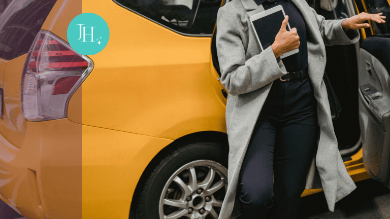 A woman in a long gray coat holding an ipad is getting out of a yellow taxi cab - Reclaim Your Power: Run Toward What You Truly Desire