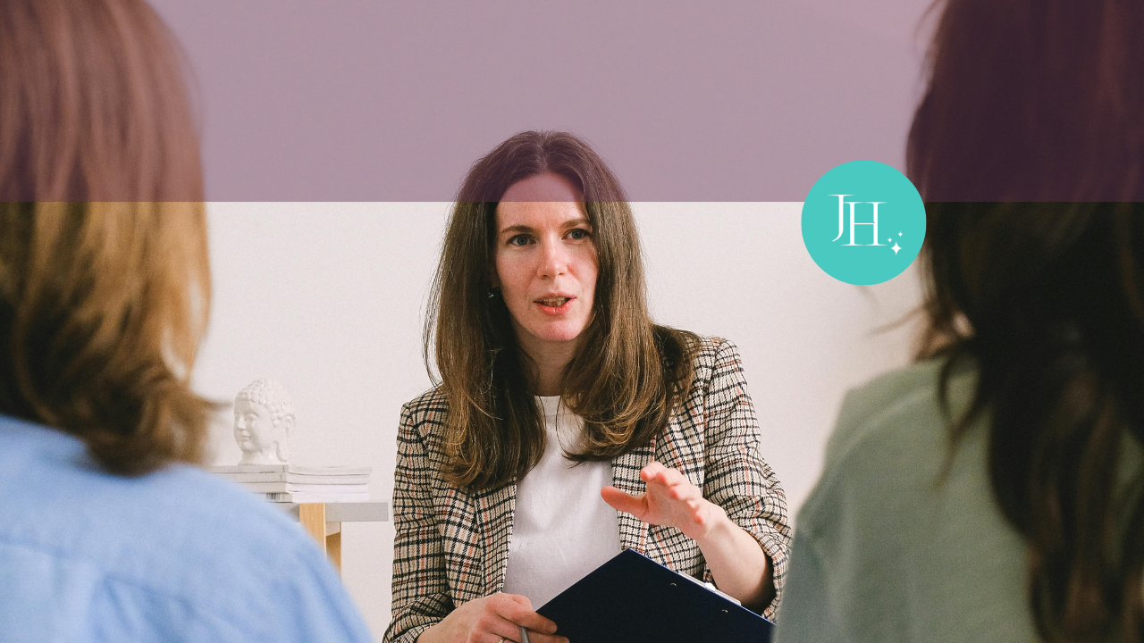 A woman in a blazer talking to two other women - Why-Are-Women-Still-Expected-to-Work-for-Free