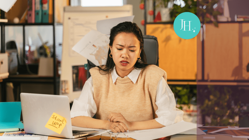 woman sitting at her desk with a frustrated look on her face - Embrace Failure: Overcoming Perfectionism for Women in Tech