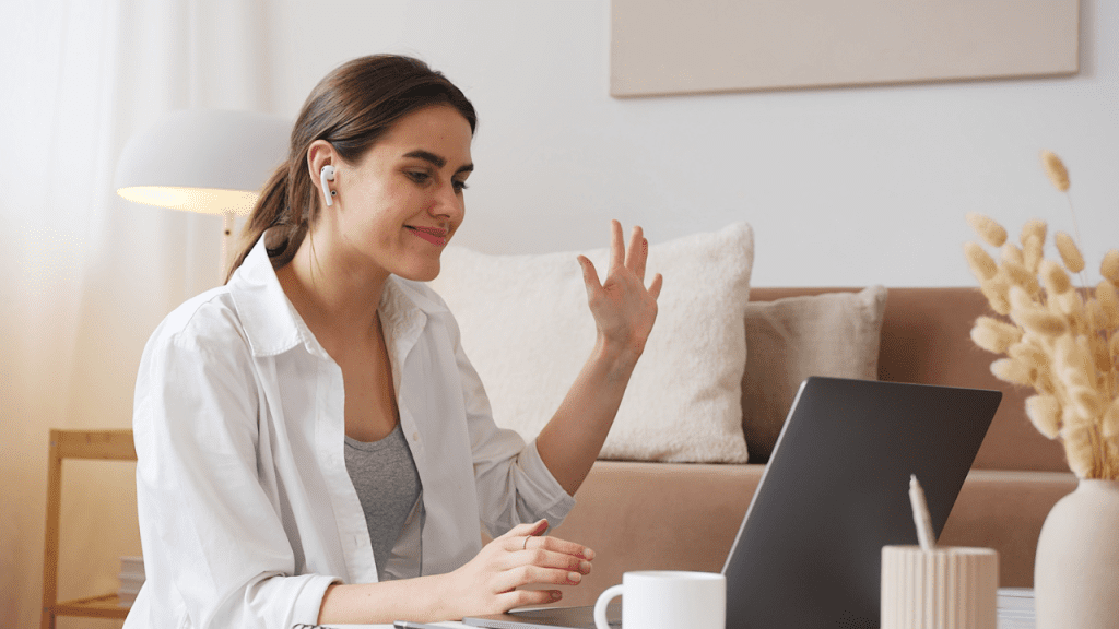 Cheerful woman having video call via laptop - lifestyle-centric career planning