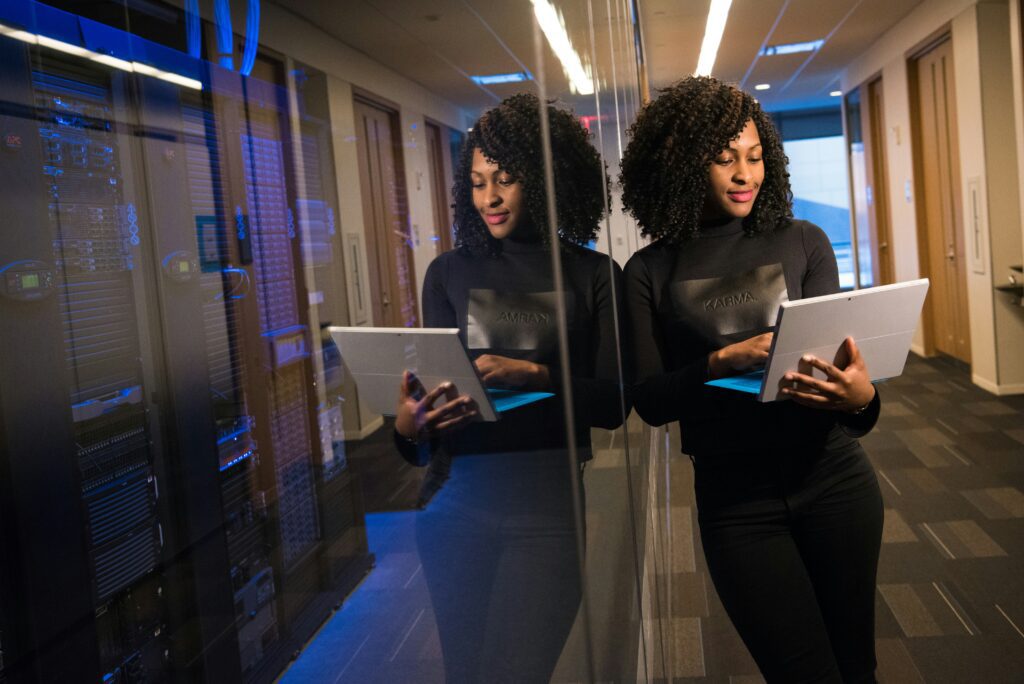 Woman using a tablet in a modern data center.